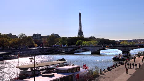seine river, eiffel tower in background, paris, france, boat traveling on river