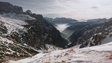 Panning-left-across-beautiful-mountain-landscape-with-snow-and-sun