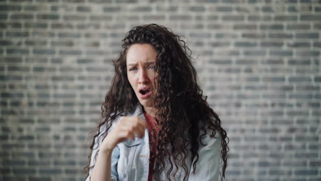 woman portrait in front of brick wall