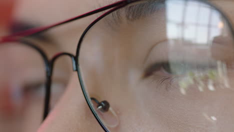 young man eyes looking out window pensive thinking planning ahead wearing glasses close up macro