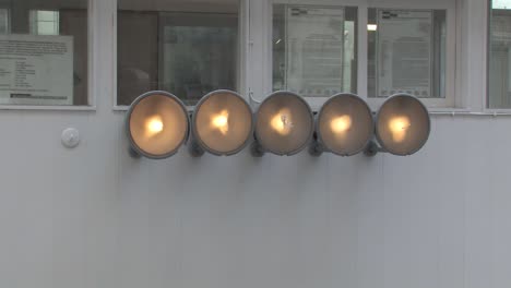 Close-up-of-spotlights-on-former-border-crossing-Checkpoint-Charlie-in-Berlin,-Germany