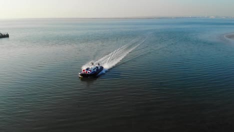 Aerial-view-of-a-hovercraft-arriving-into-Ryde-Hoverport,-Isle-of-Wight,-from-Portsmouth,-UK