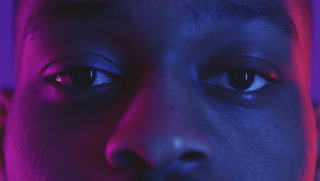 close-up portrait of a man with neon lighting