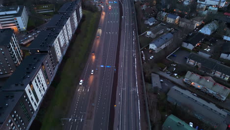 high angle drone shot over traffic on the helsingin valtatie road, dusk in turku
