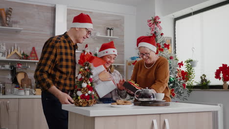 Grandparents-giving-wrapper-xmas-gift-with-ribbon-on-it-to-granddaughter