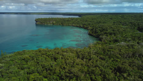 flyover above bay of jinek, coast of lifou island