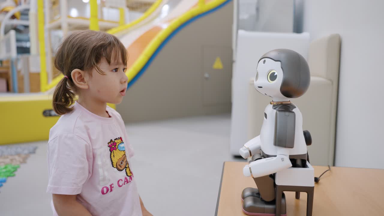 Little Girl Interacting with a Friendly Robot
