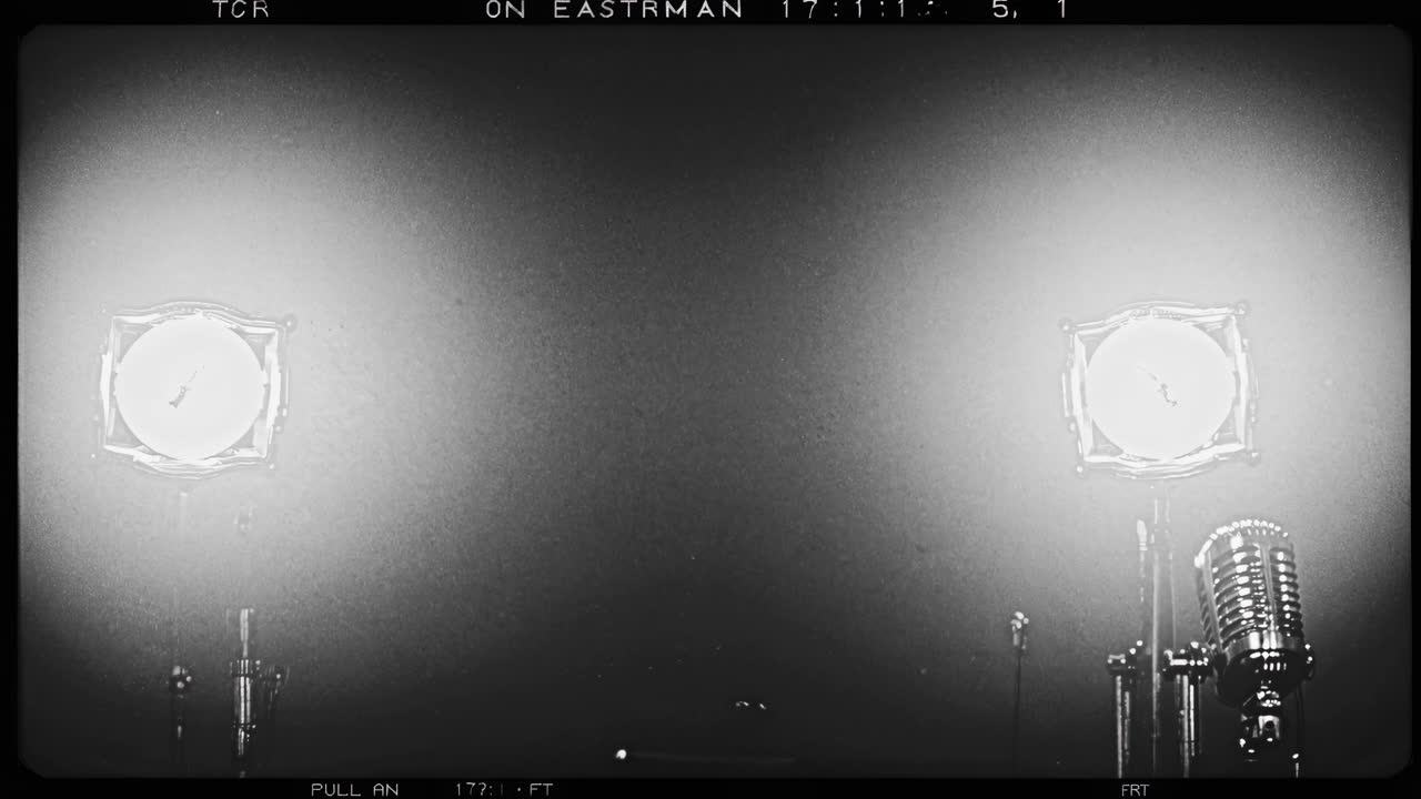 Empty recording studio illuminated by spotlights with a vintage microphone in the foreground, creating a nostalgic atmosphere of anticipation