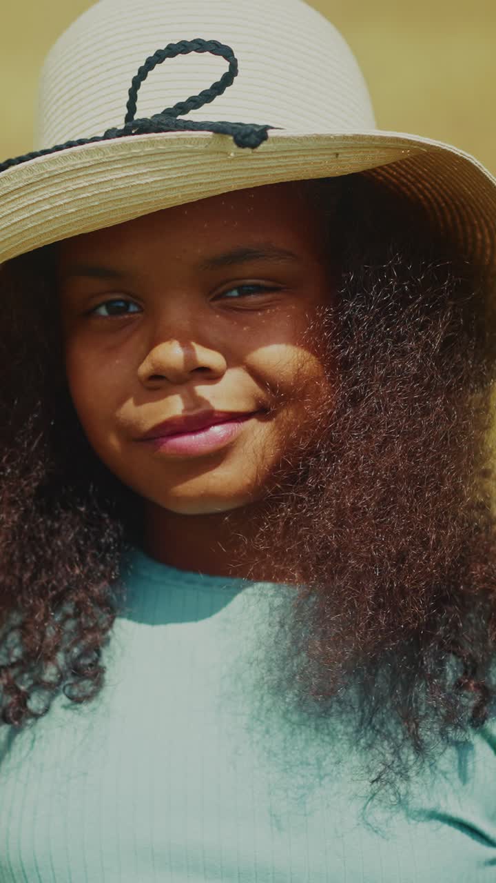 Young Girl Wearing a Straw Hat