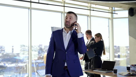 happy businessman having a phone conversation. partners working in office centre developing new strategies. business people in the company.