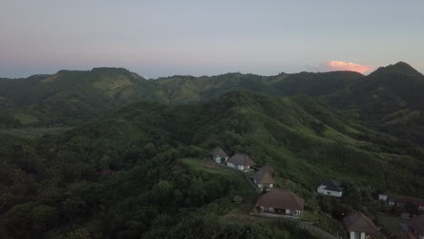 aerial flight past hilltop villas on tropical island of lombok, idn