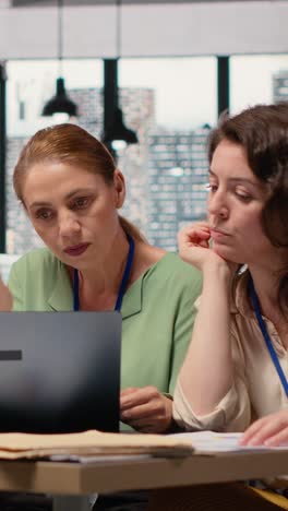 vertical video confident powerful women gathering in the boardroom to evaluate data reports
