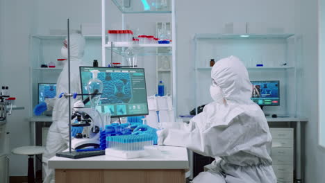 biochemist in coverall checking manifestations of virus