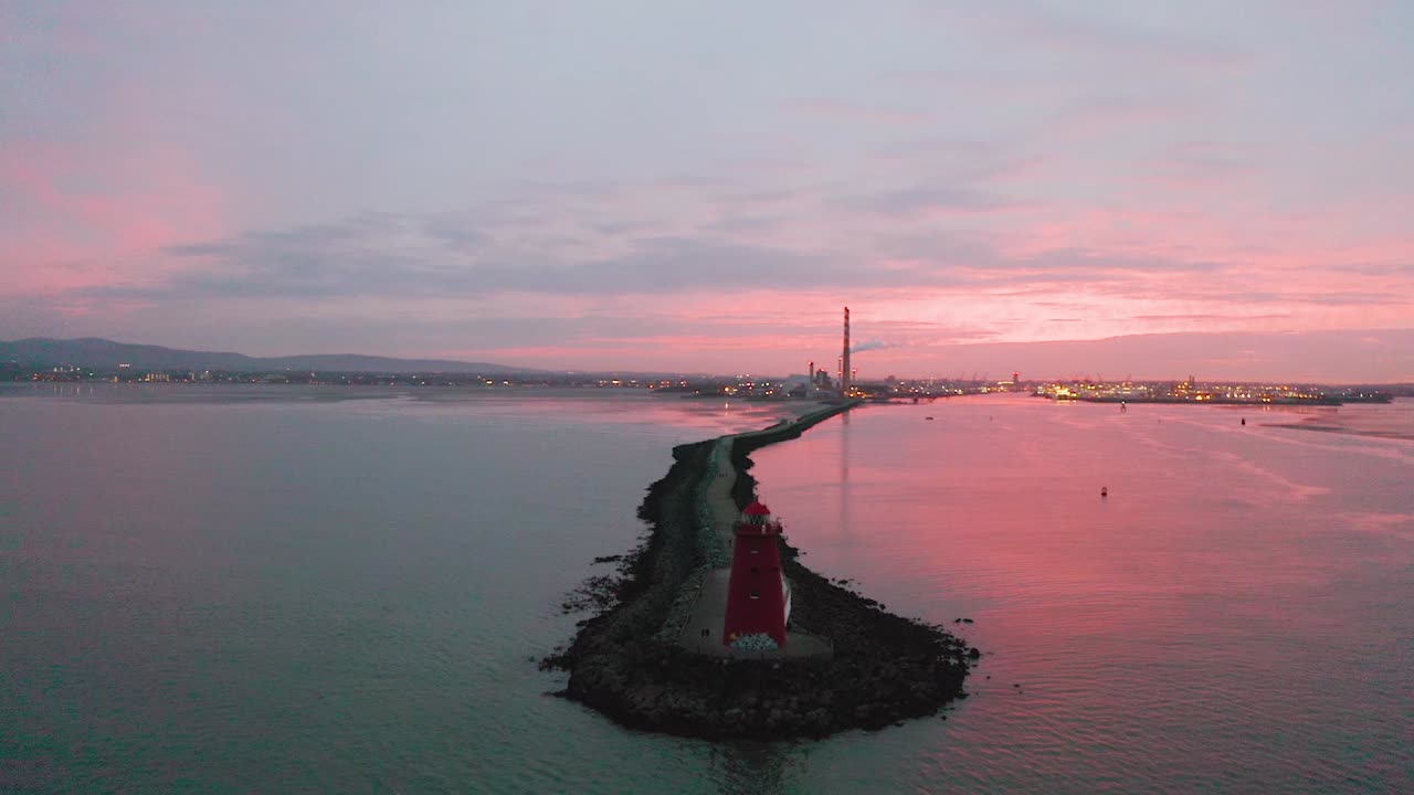 Stunning Sunset over a Lighthouse and Industrial Port