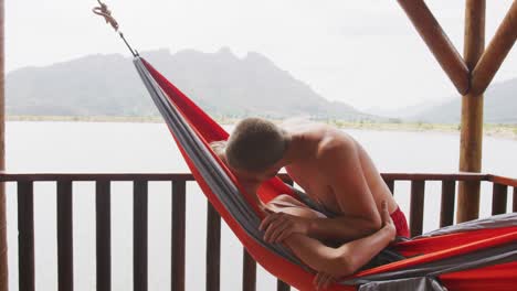 caucasian couple spending time at home, kissing outide the cabin