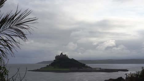 view from a terrace in marazion of the english medieval castle and church of st michael's mount in cornwall on a cloudy spring day