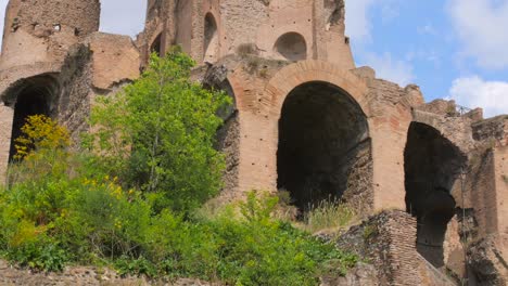 low angle shot of ruins of roman circus maximus against blue sky in rome, italy at daytime