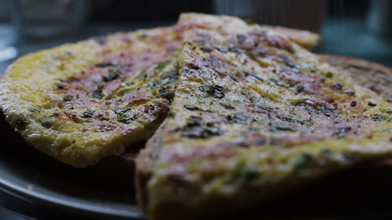 Close-up shot of Salt and Pepper being Sprinkled on a Smoking Hot Omelette!