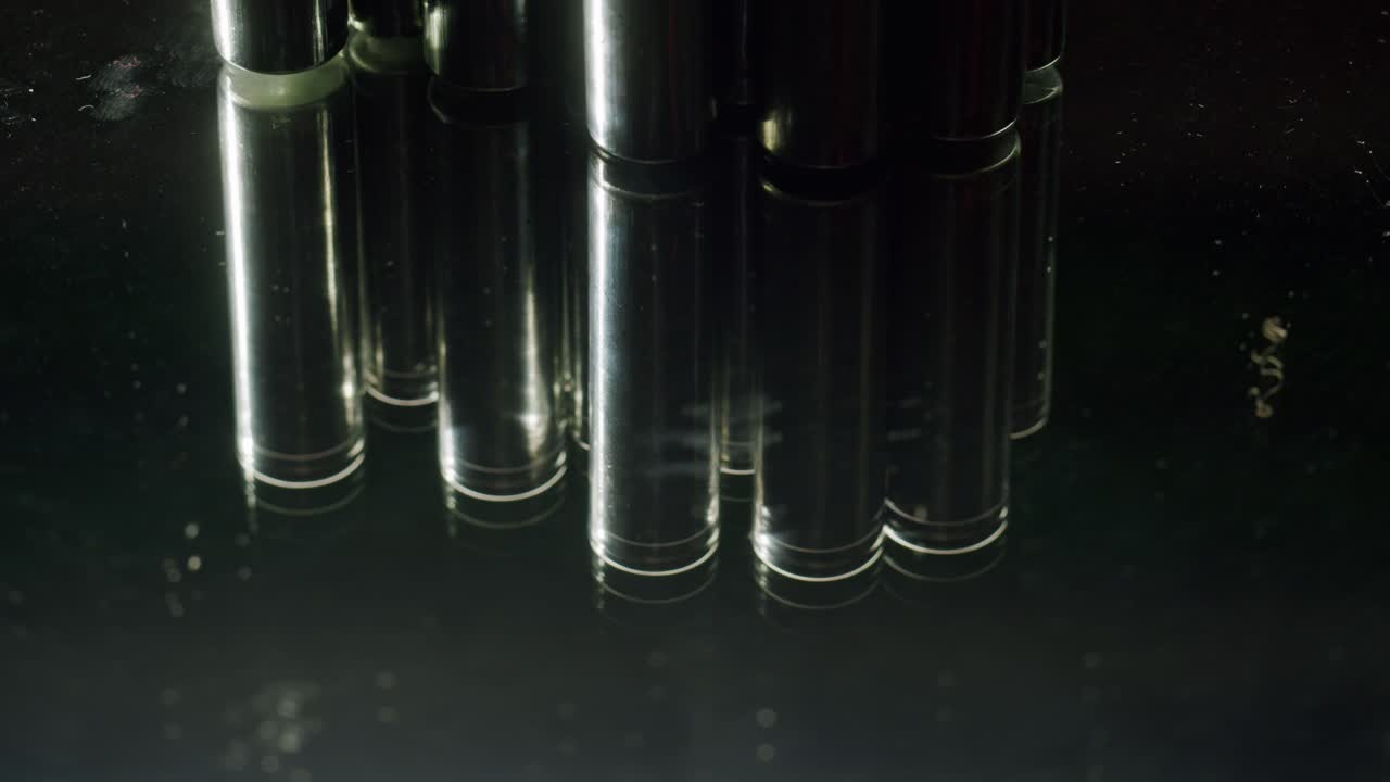 Silver batteries AA and AAA on black background close-up. Double-A battery is a standard size single cell cylindrical dry battery. Batteries are common in portable electronic devices. An AA battery is composed of a single electrochemical cell that may be either a primary battery or a rechargeable ba