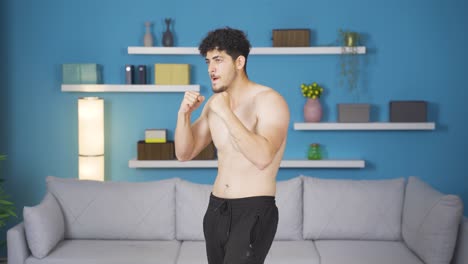 athlete man practicing shadow boxing at home. healthy lifestyle.