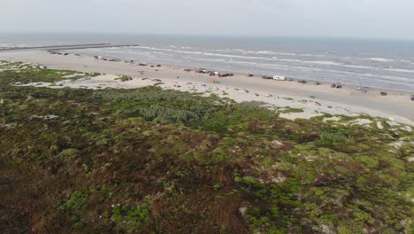 Pull-back-from-the-jetty-and-ocean-over-the-grasslands