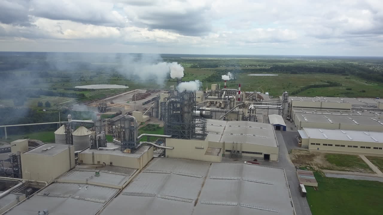 Aerial view of industrial facility with smoking pipes