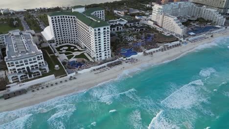 Aerial-tilts-up-to-exclusive-resort-hotels-on-Cancun's-Caribbean-coast