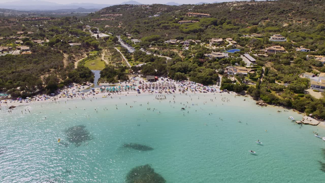 Aerial View of a Crowded Turquoise Beach on a Sunny Day