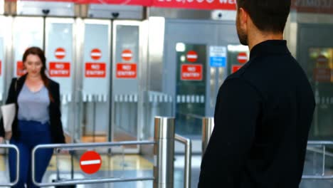 man embracing woman while arriving