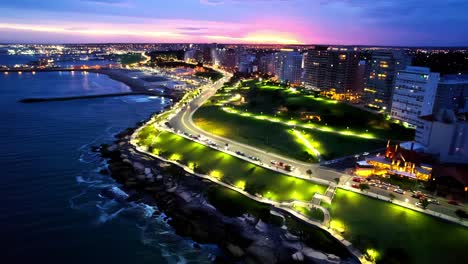 colorful panoramic aerial orbit of plaza españa urban waterfront park at night, mar del plata, argentina