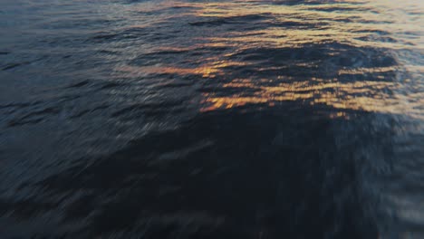 a drone flight over the ocean in the direction of the sunset