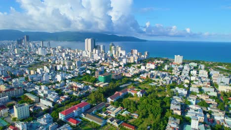 aerial establishing shot of vietnamese beach city hotels and buildings, da nang, vietnam