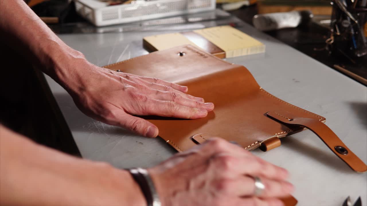 Artisan Leatherworker Polishing a Book Cover