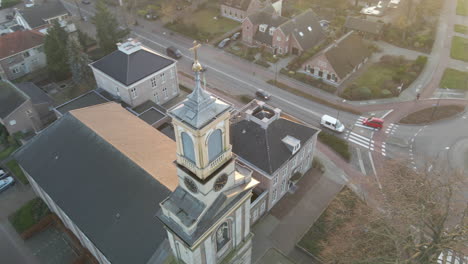 Aerial-of-church-tower-in-a-busy-rural-town-center