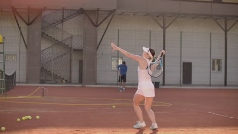 tennis game on sunny day at tennis court young sportive woman playing.