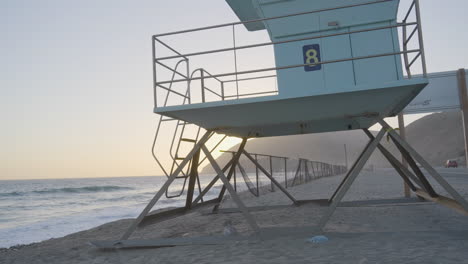 ascending shot of lifeguard tower at mondo's beach as the sun sets located in southern california