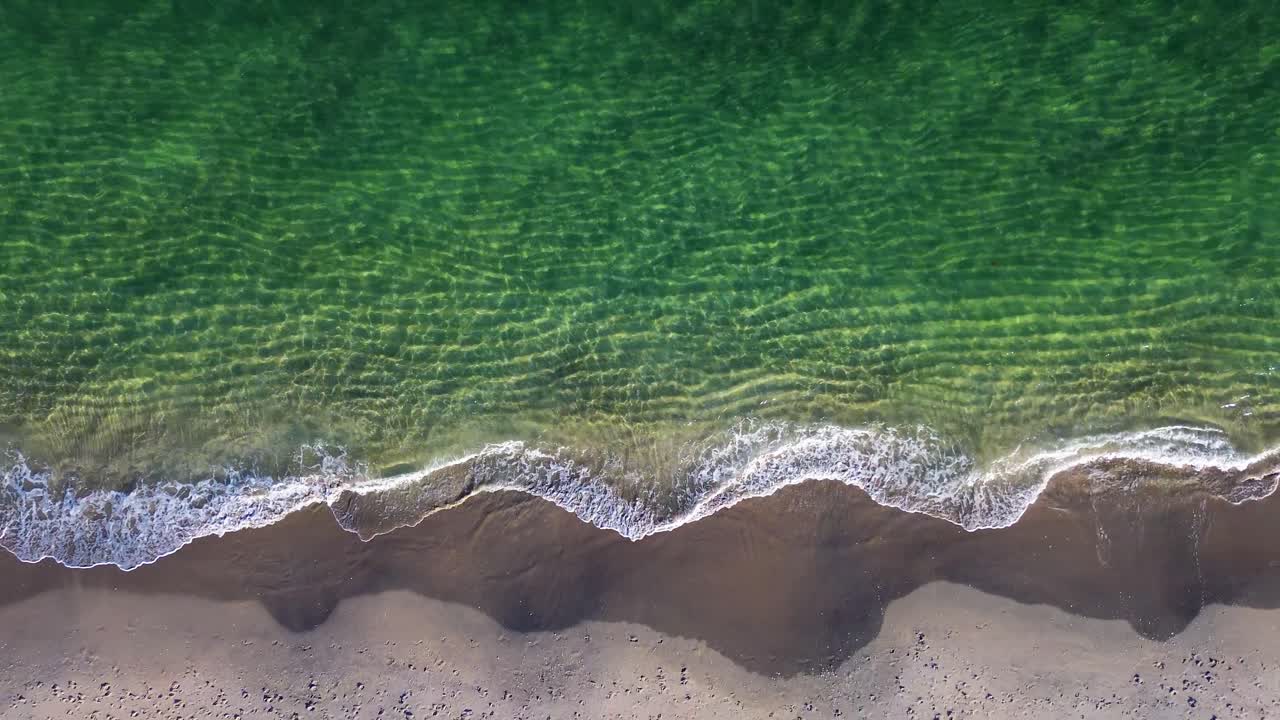 A beautiful drone video rising above a crystal clear beach in South Florida.