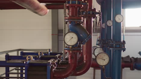 metal pipes with manometers and pumps in mechanical room