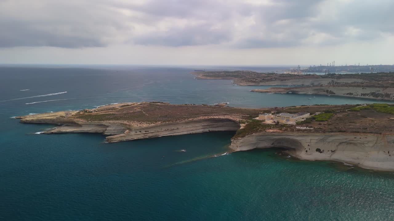 A stunning aerial view of the Mediterranean coast of southern Malta with full of rocky coves and water caves, near Marsaxlokk