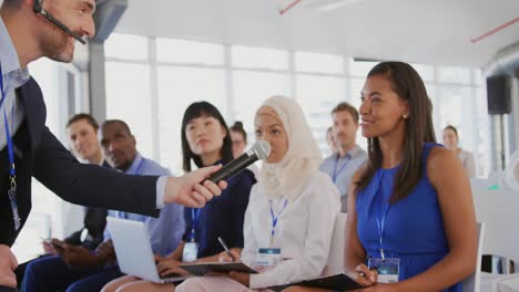 woman answering at a question during a seminar