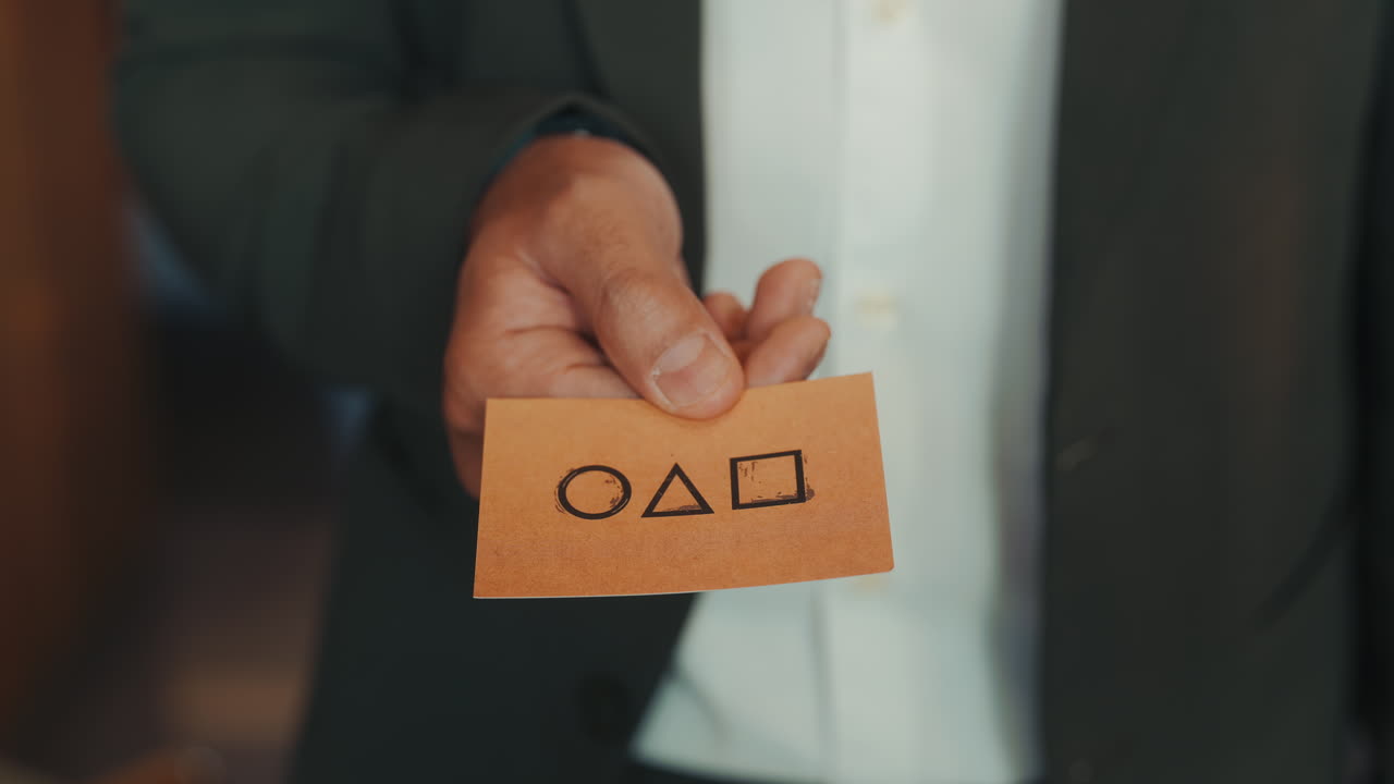 Person holding a card with shapes