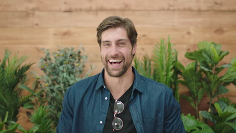 attractive young man portrait of handsome caucasian guy laughing cheerful at camera