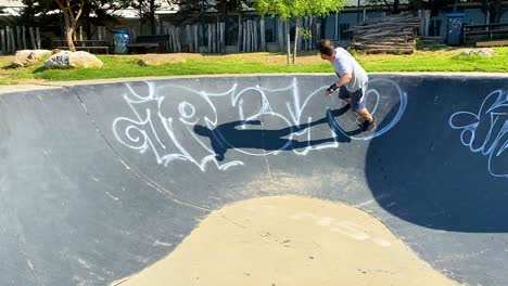 man training the surf level climbing to the wall using a skateboard in park of generations in cascais, europe