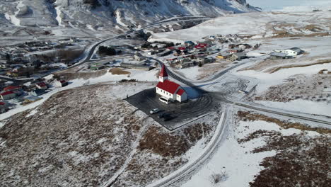 Experience-the-serene-beauty-of-a-Catholic-church-nestled-in-the-stunning-landscape-of-Iceland,-with-a-beach-just-steps-away