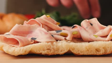 making a sandwich with prosciutto and bread