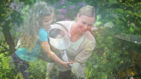 spots of light against caucasian mother and daughter watering plants in the garden