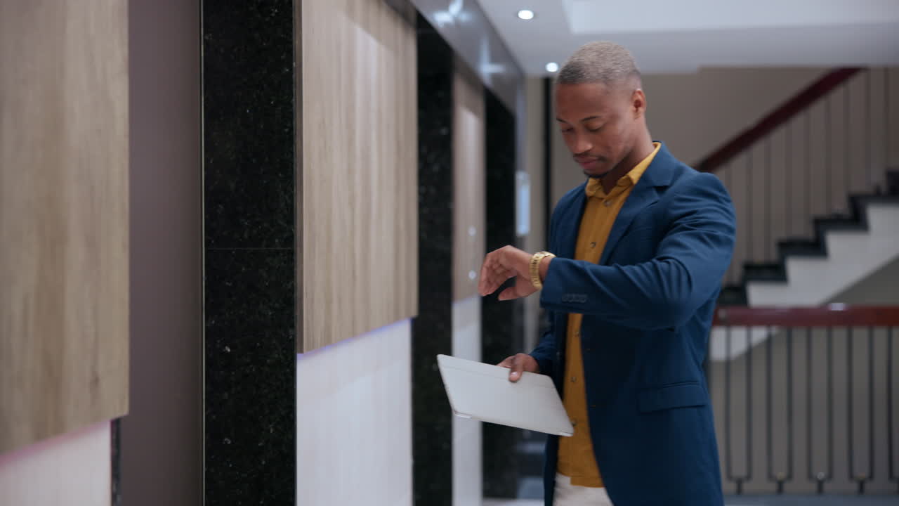 Man in suit waiting for elevator