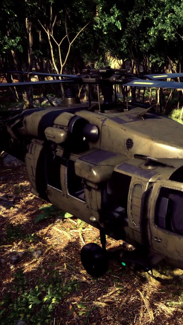 Military helicopter on the ground in a forest area during daytime