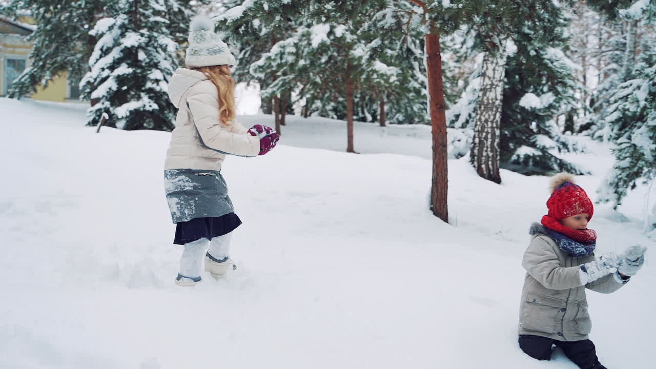 Child play outdoors in snow. Outdoor fun for family Christmas vacation.