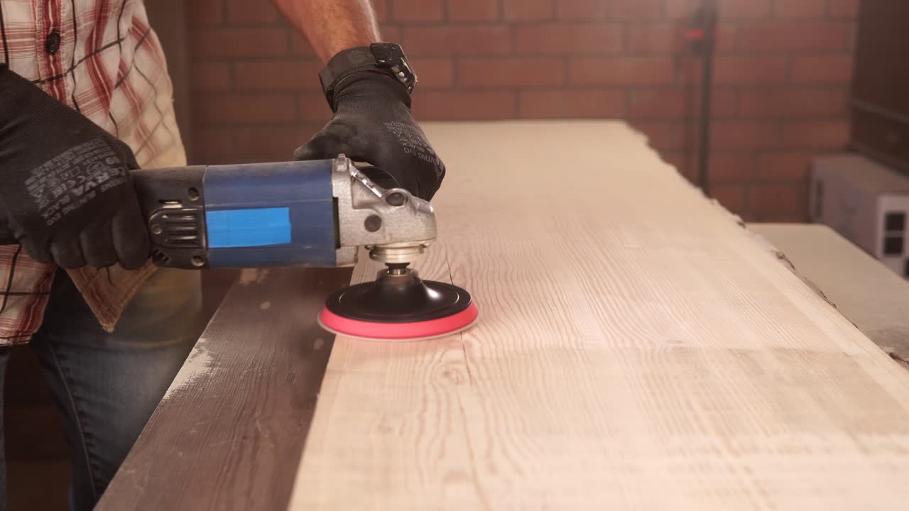 Man Sanding a Wooden Plank with a Power Sander